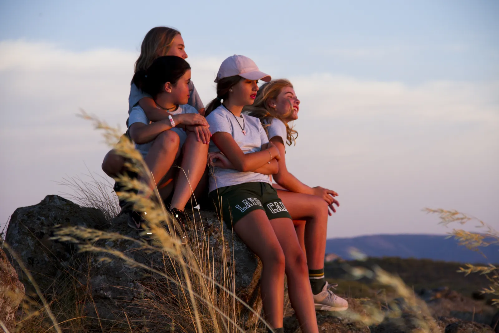 Campers watching the sunset from the rocks in Toledo